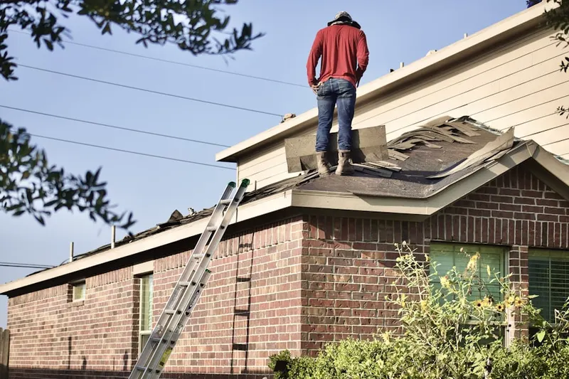 Professional roofer working on a residential roof in Sunburst Farms